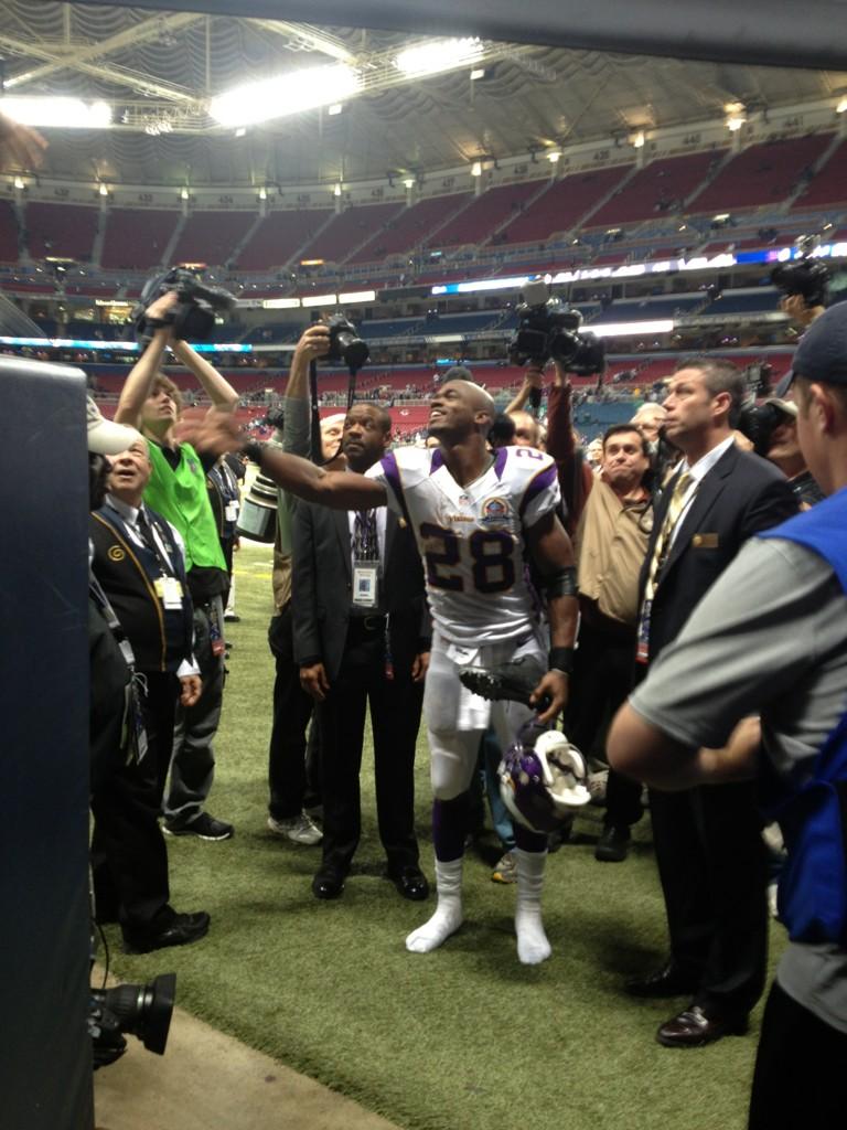 Adrian celebrating the win by giving out his shows to kids